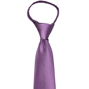 Knot and front of a wisteria purple zipper tie