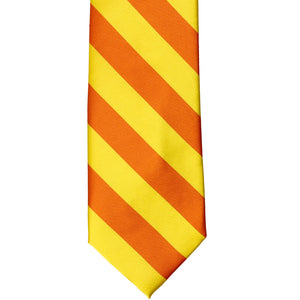 The front of a yellow and orange striped tie, laid out flat