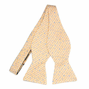 An untied soft orange yellow white and light blue plaid self-tie bow tie